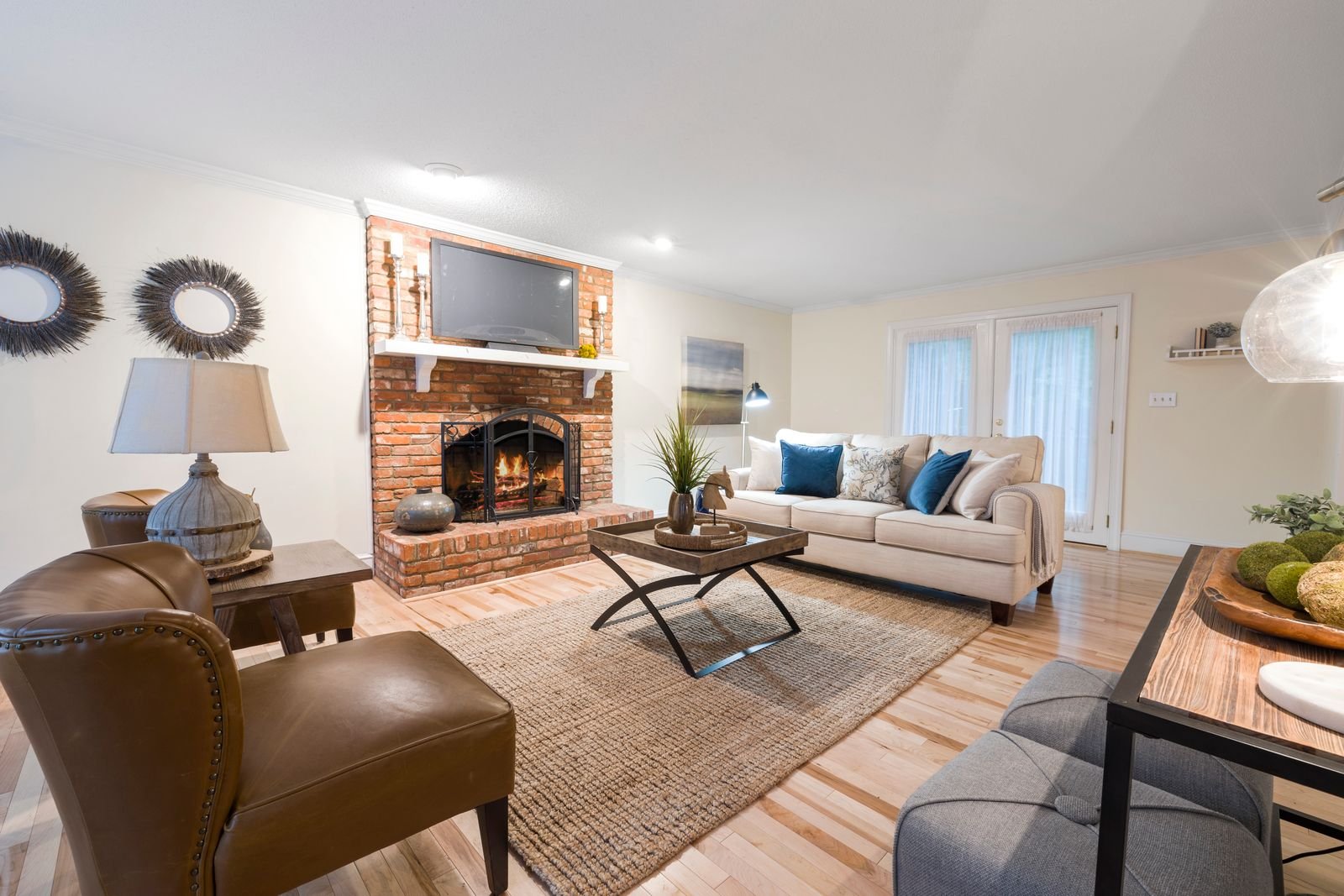 An inviting living room with cosy seating around a brick fireplace